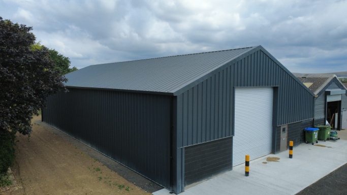 New metal roof and vertical cladding installed on agricultural building
