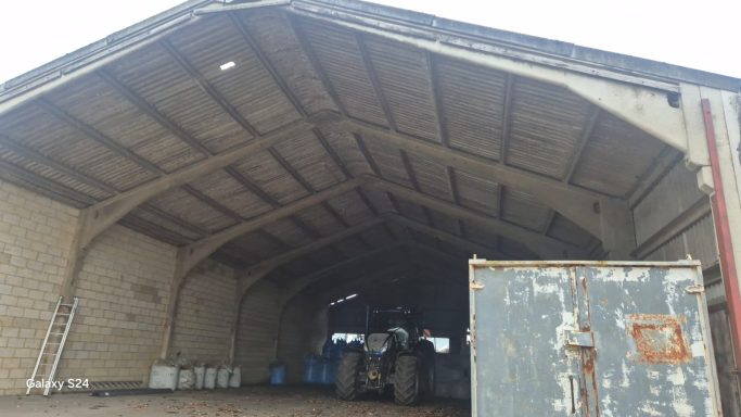 New metal roof and vertical cladding installed on agricultural building