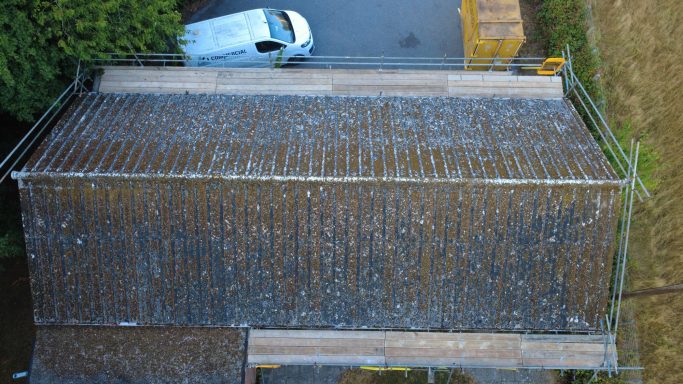New insulated metal roof installed after asbestos roof removal on village hall