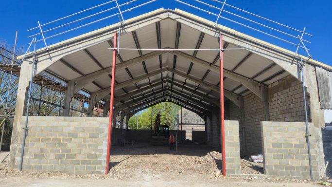 New metal roof and vertical cladding installed on agricultural building