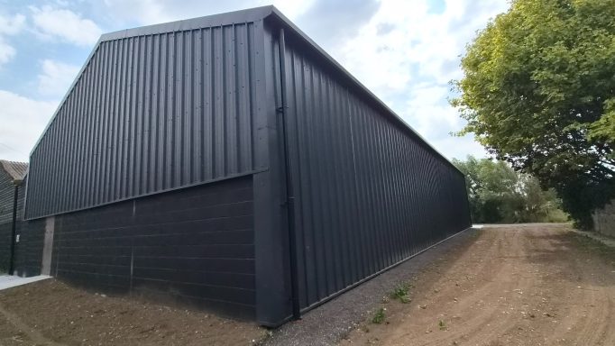 New metal roof and vertical cladding installed on agricultural building