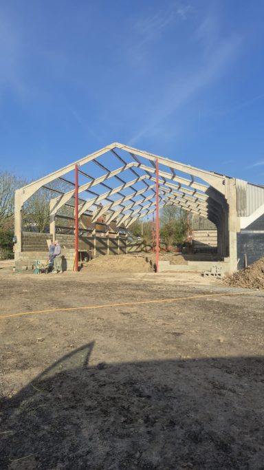 New metal roof and vertical cladding installed on agricultural building