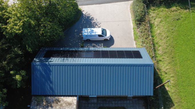 New insulated metal roof installed after asbestos roof removal on village hall